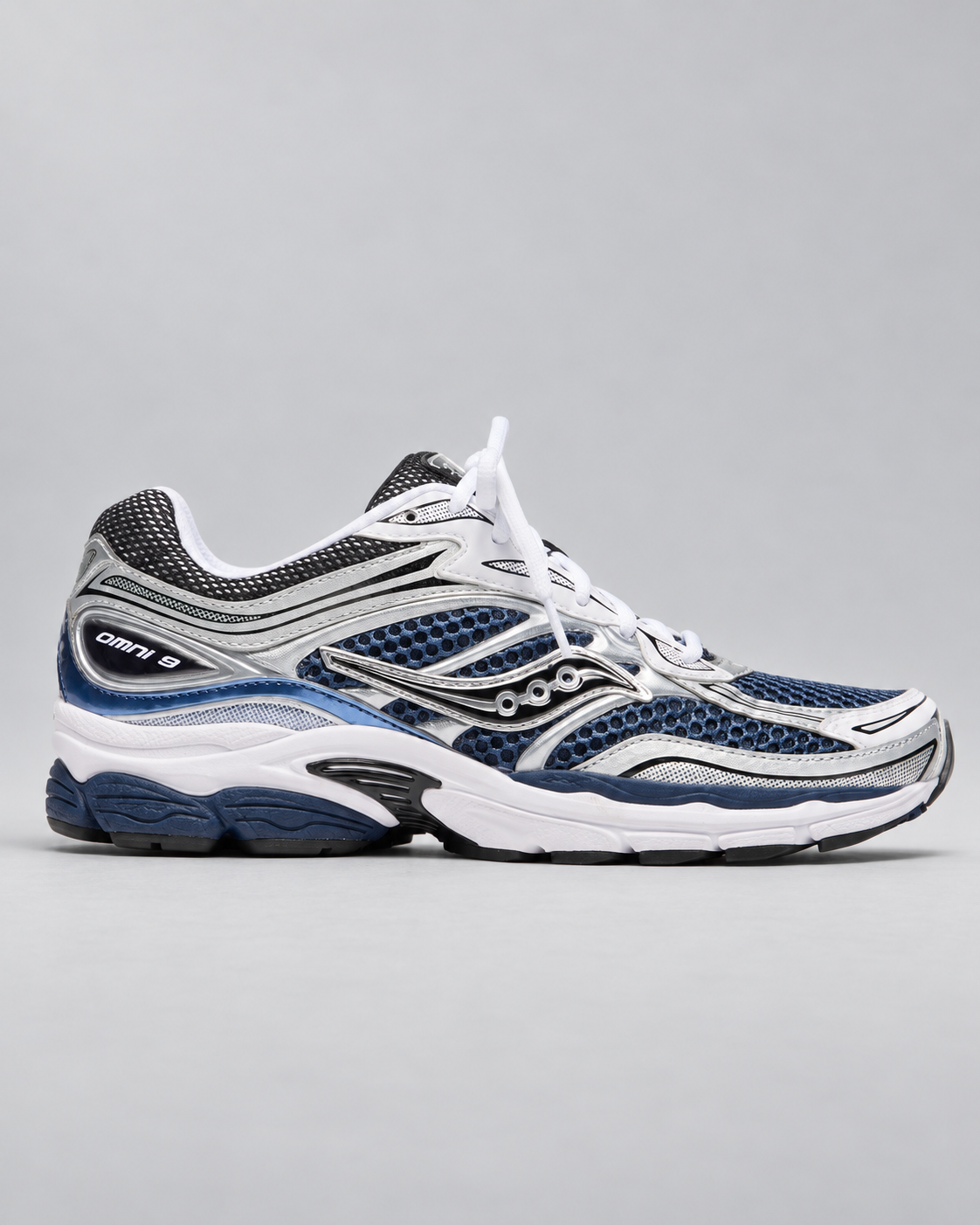 Saucony ProGrid Omni 9 Deep Navy, lateral view on a light grey studio background