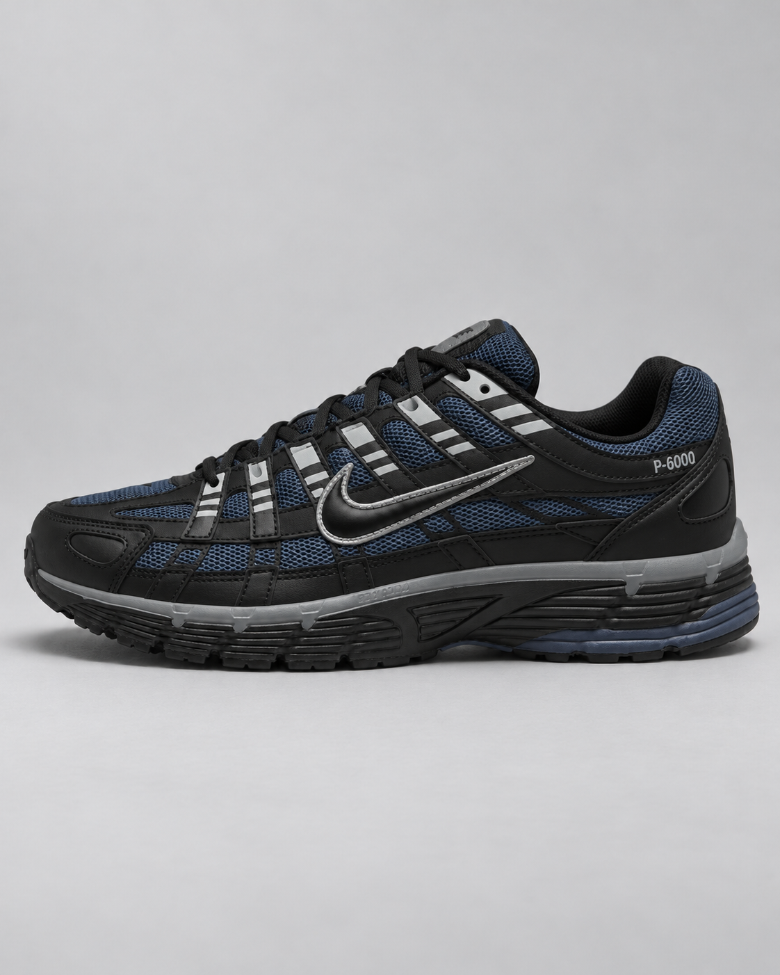 Nike P-6000 Diffused Blue with black overlays and navy blue mesh on a light-grey studio background